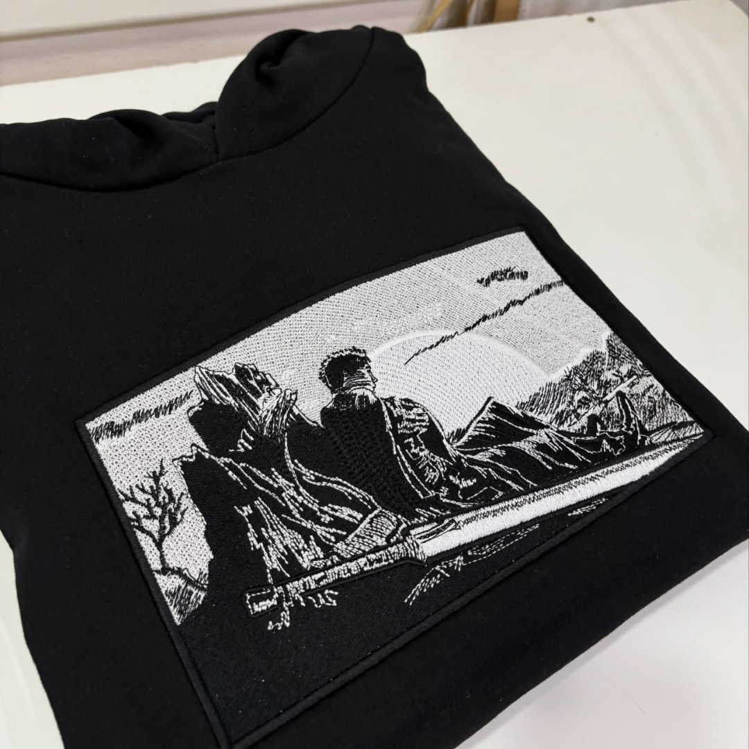 Berserk boxed embroidery design stitched by a customer on a black hoodie